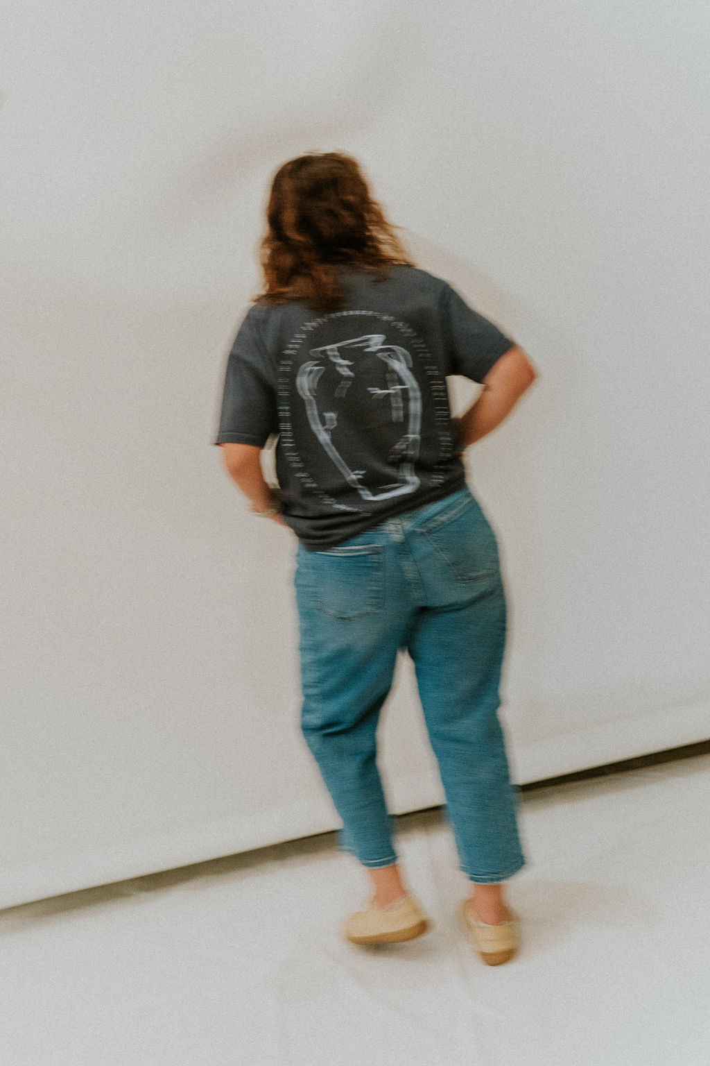 The back of a t-shirt printed with a clay vase illustration